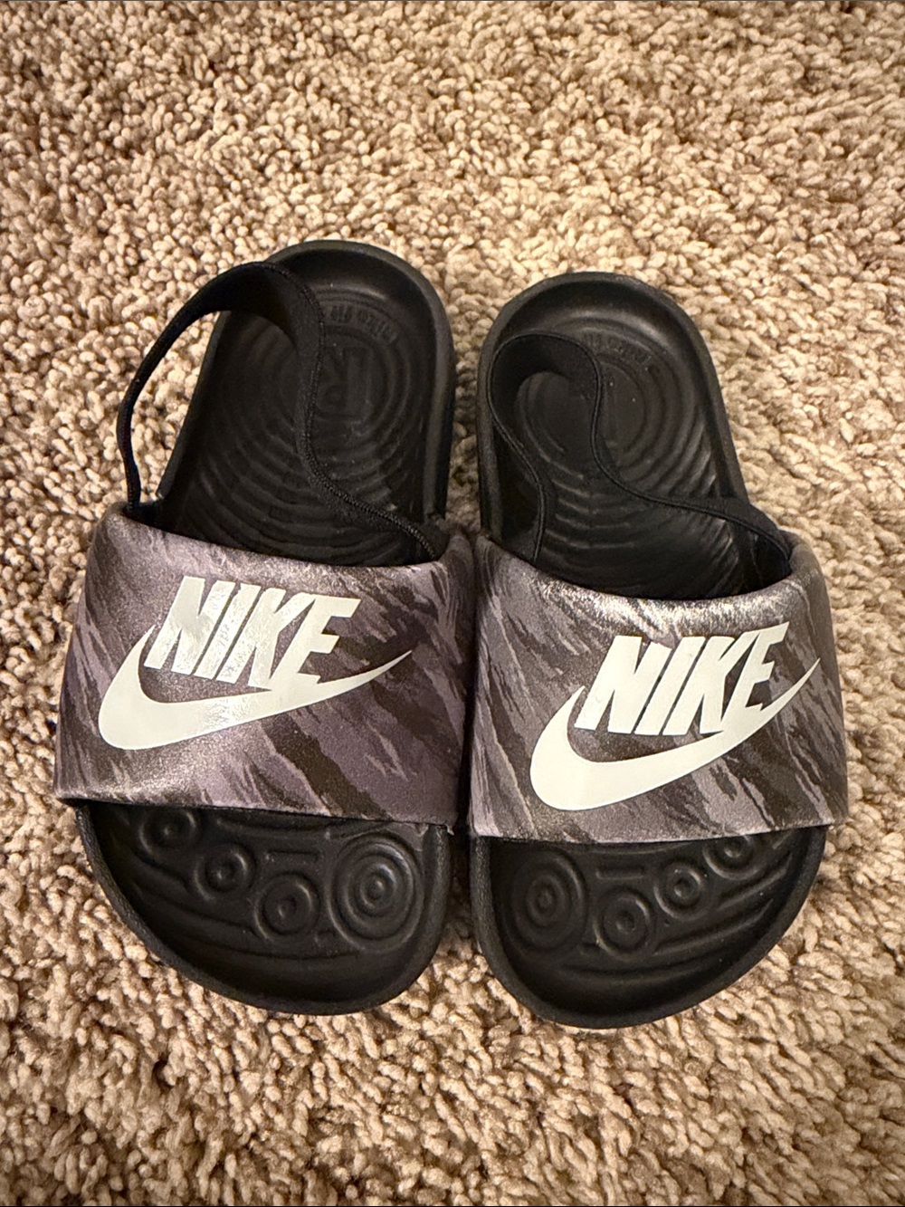 Nike Kids Black Slide Sandals with Gray Patterned Strap and White Logo